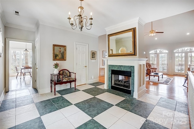 4633 River Bluff Ct, Charlotte, NC 28214 - living room featuring plenty of natural light, crown molding, visible vents, and a premium fireplace
