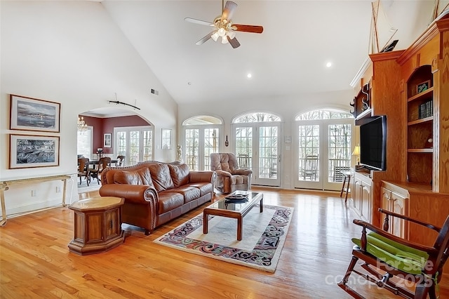 4633 River Bluff Ct, Charlotte, NC 28214 - living room featuring light wood-type flooring, arched walkways, high vaulted ceiling, and a ceiling fan