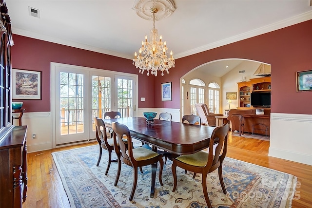 4633 River Bluff Ct, Charlotte, NC 28214 - dining space with arched walkways, visible vents, plenty of natural light, and light wood-style floors