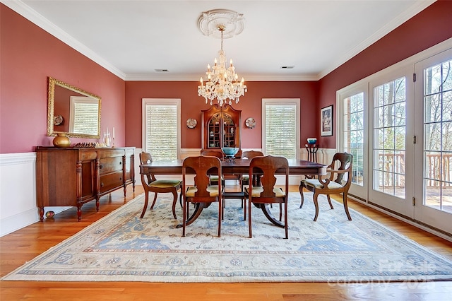 4633 River Bluff Ct, Charlotte, NC 28214 - dining area featuring visible vents, an inviting chandelier, wood finished floors, and ornamental molding