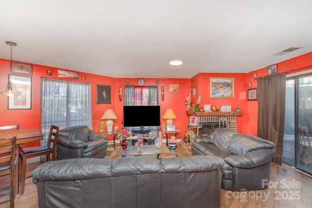 8175 Cedar Glen Dr, Charlotte, NC 28212 - living area with visible vents, a healthy amount of sunlight, and wood finished floors