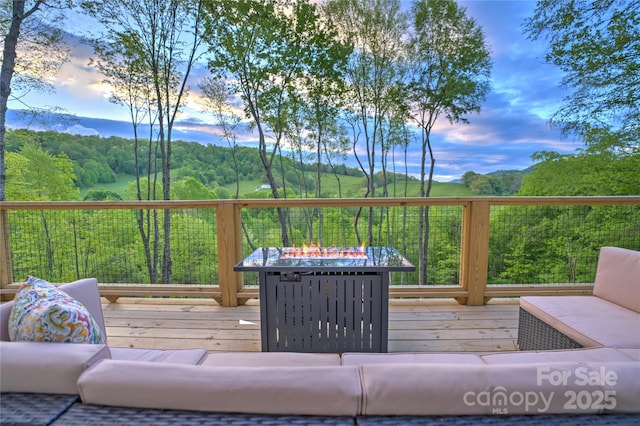 145 Banjo Ln, Waynesville, NC 28785 - deck at dusk with an outdoor fire pit and a forest view