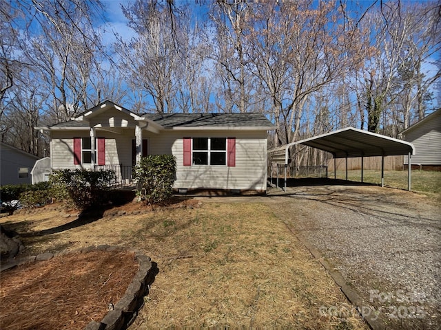 view of front facade featuring a detached carport, a porch, and driveway