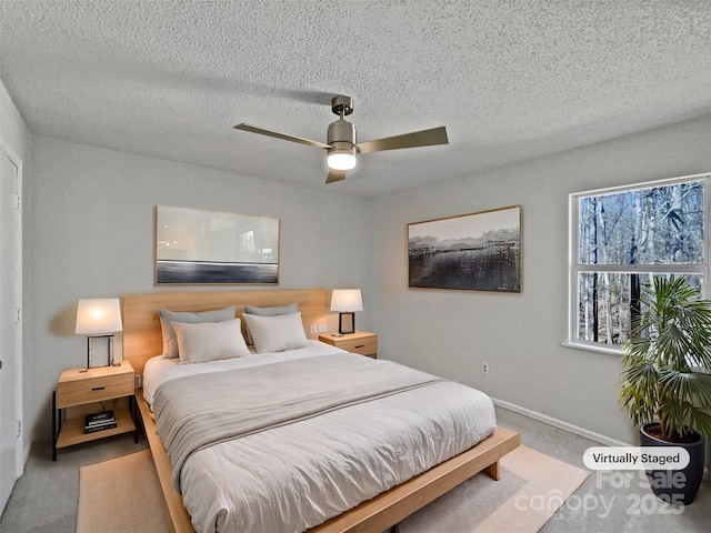 bedroom featuring baseboards, a textured ceiling, ceiling fan, and carpet flooring