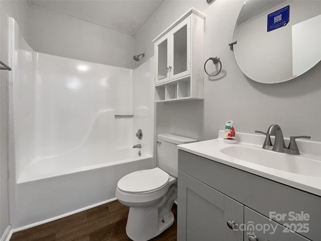 full bathroom with toilet, shower / washtub combination, wood finished floors, and vanity