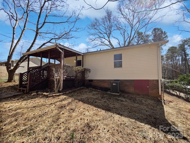 back of house with crawl space, a wooden deck, cooling unit, and fence