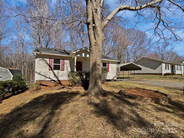 ranch-style house with a carport, dirt driveway, and crawl space