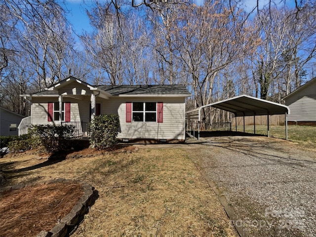 view of front of property with crawl space, aphalt driveway, a carport, and covered porch
