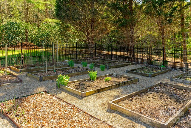 view of yard with a vegetable garden and fence