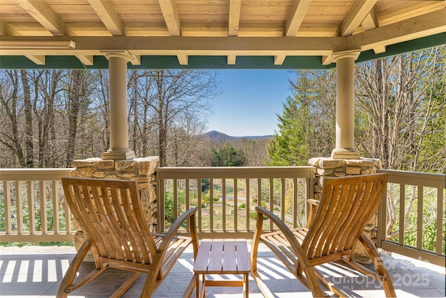 wooden deck with a mountain view