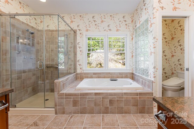bathroom with a stall shower, wallpapered walls, and vanity