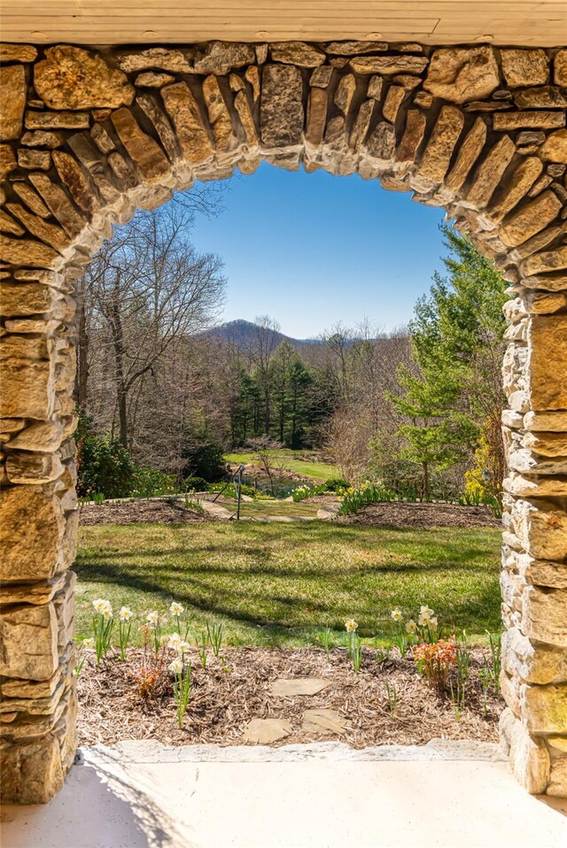 exterior space with a wooded view and a mountain view