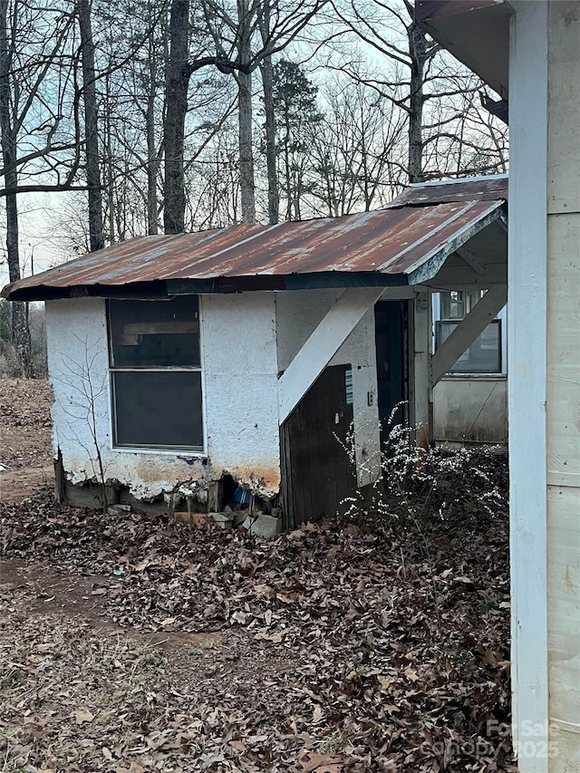 view of side of home featuring metal roof
