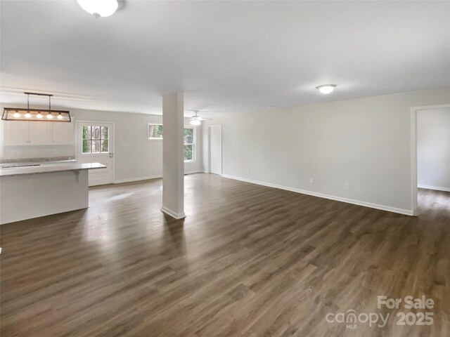 510 Newport Dr, Salisbury, NC 28144 - unfurnished living room featuring baseboards, ceiling fan, and dark wood-style flooring