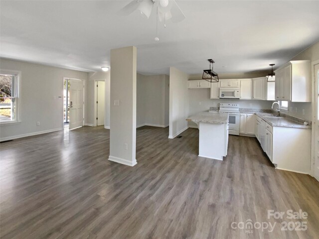510 Newport Dr, Salisbury, NC 28144 - kitchen with a center island, open floor plan, white appliances, white cabinetry, and a sink
