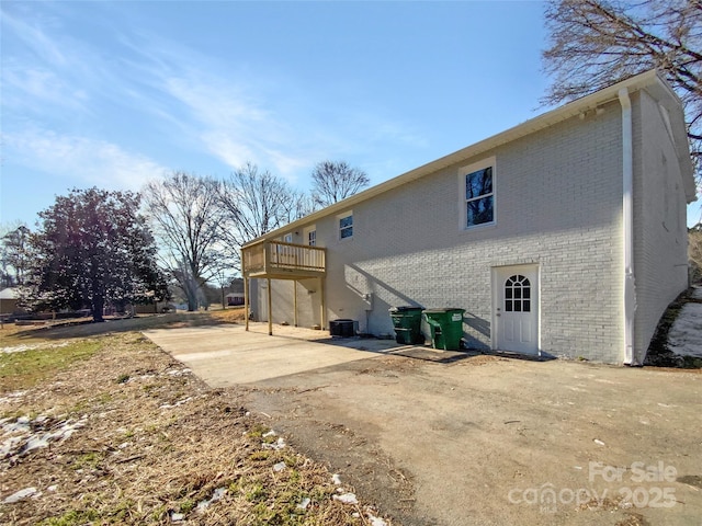 510 Newport Dr, Salisbury, NC 28144 - rear view of house featuring stairs, cooling unit, brick siding, and a wooden deck