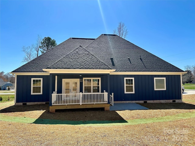 rear view of house featuring crawl space, board and batten siding, and french doors
