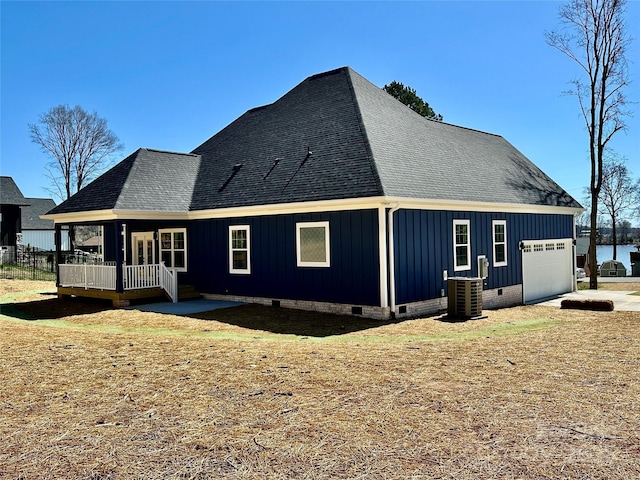 view of home's exterior with cooling unit, roof with shingles, a garage, crawl space, and board and batten siding