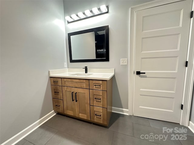 bathroom with tile patterned floors, baseboards, and vanity