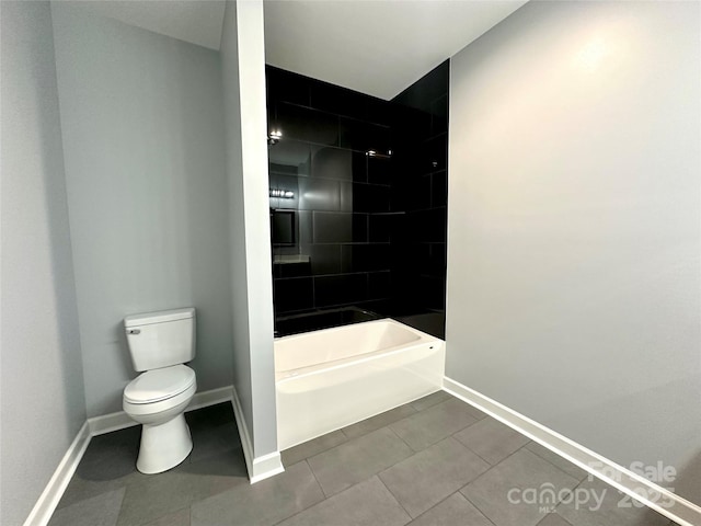 bathroom featuring tile patterned flooring, toilet, and baseboards