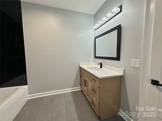 full bath featuring baseboards, vanity, and tile patterned flooring