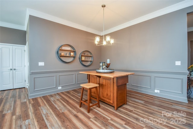 1638 Sweetmoss Loop, Denver, NC 28037 - dining room featuring ornamental molding, wood finished floors, a decorative wall, a chandelier, and wainscoting