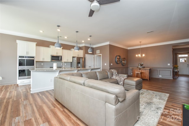 1638 Sweetmoss Loop, Denver, NC 28037 - living area featuring a chandelier, light wood-style flooring, a ceiling fan, crown molding, and recessed lighting