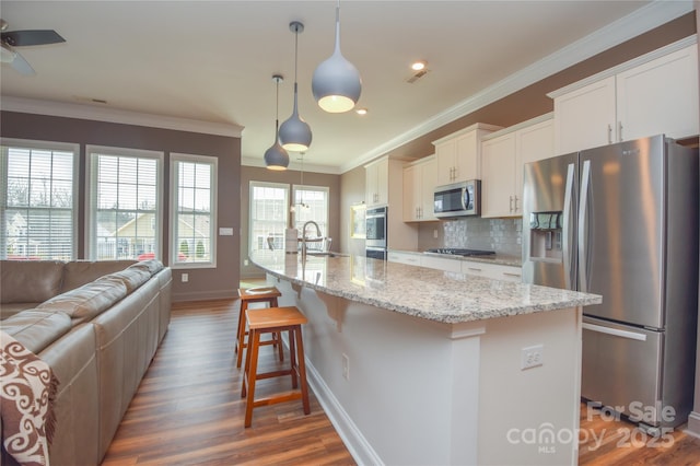 1638 Sweetmoss Loop, Denver, NC 28037 - kitchen with stainless steel appliances, white cabinets, ornamental molding, tasteful backsplash, and wood finished floors