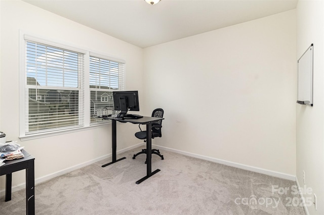 carpeted office space with baseboards