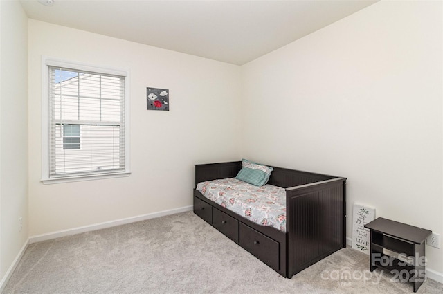 bedroom featuring baseboards and carpet