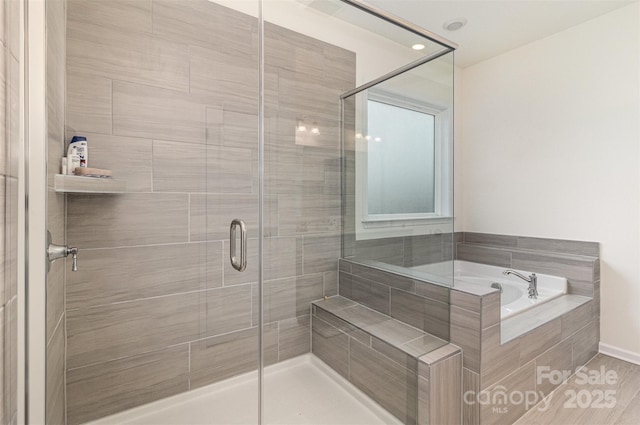 full bathroom with a stall shower and a garden tub