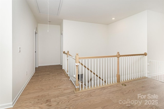 corridor featuring baseboards, an upstairs landing, recessed lighting, attic access, and wood finished floors