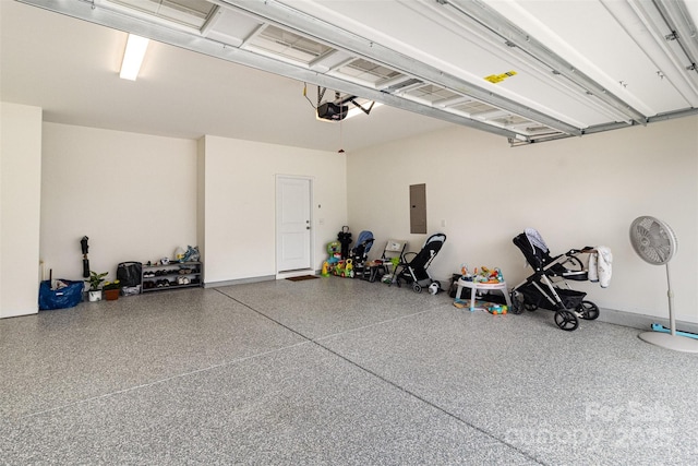 garage featuring electric panel and a garage door opener