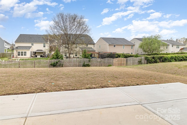 view of yard with a residential view and fence