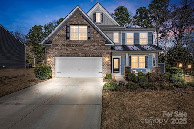 craftsman inspired home featuring a garage, brick siding, driveway, and a standing seam roof