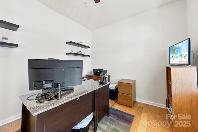 office with light wood-style flooring, baseboards, and a ceiling fan