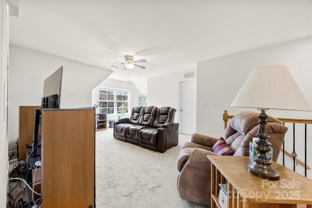 carpeted living area featuring visible vents, lofted ceiling, and ceiling fan