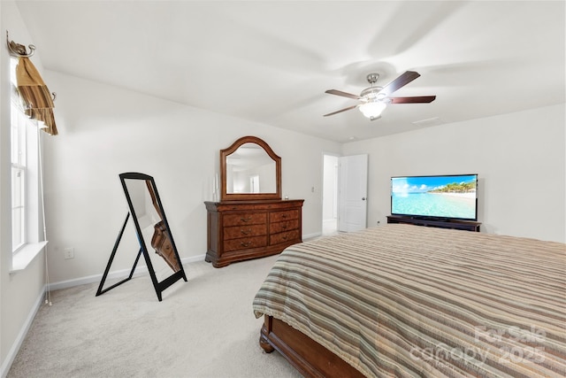 bedroom with visible vents, baseboards, light colored carpet, and ceiling fan