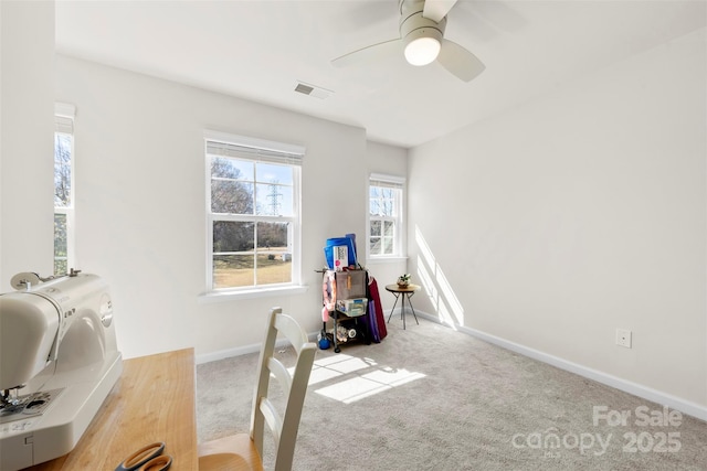 office area with visible vents, ceiling fan, baseboards, and carpet