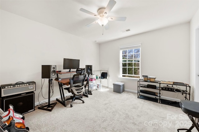 carpeted office space featuring visible vents, baseboards, and ceiling fan