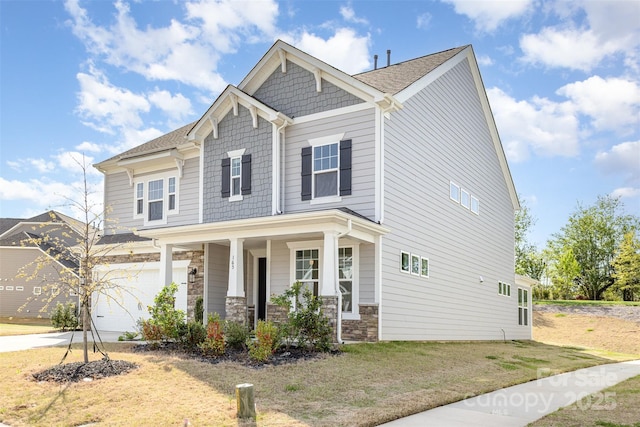 165 Winterberry St, Mooresville, NC 28117 - craftsman-style home with a garage, covered porch, a front yard, stone siding, and driveway