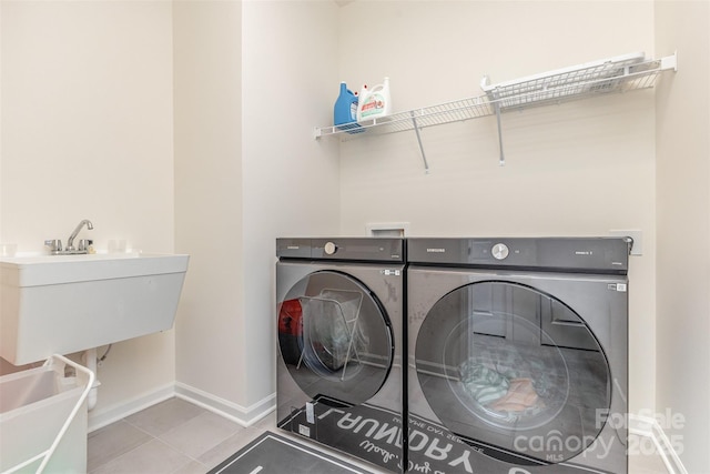 165 Winterberry St, Mooresville, NC 28117 - laundry room with tile patterned floors, washing machine and clothes dryer, laundry area, and baseboards