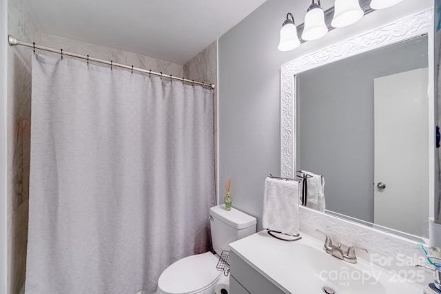 bathroom featuring vanity, a shower with shower curtain, and toilet