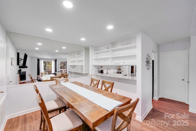 dining room featuring recessed lighting, baseboards, and light wood-style floors