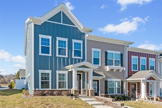 view of front of house with board and batten siding and a front lawn