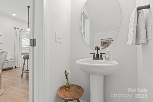 bathroom with recessed lighting and wood finished floors