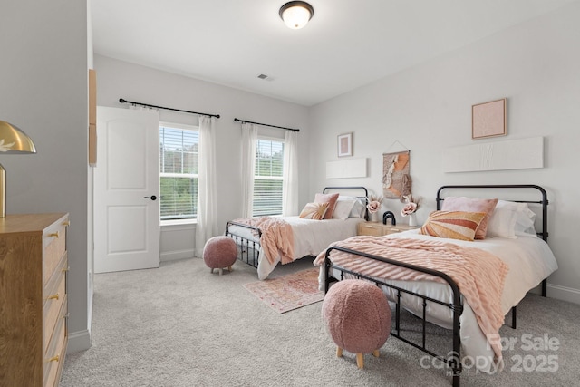 bedroom with visible vents, light colored carpet, and baseboards
