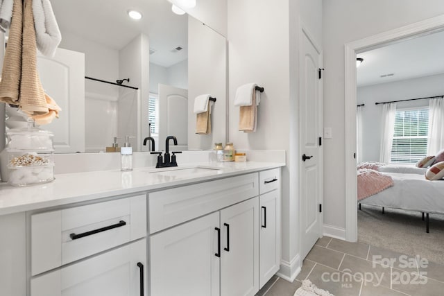 bathroom featuring visible vents, connected bathroom, baseboards, tile patterned floors, and vanity
