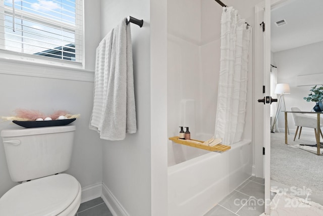 bathroom with tile patterned flooring, visible vents, baseboards, toilet, and shower / bath combo with shower curtain