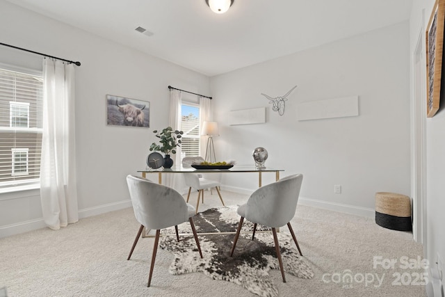 dining space with visible vents, baseboards, and carpet flooring